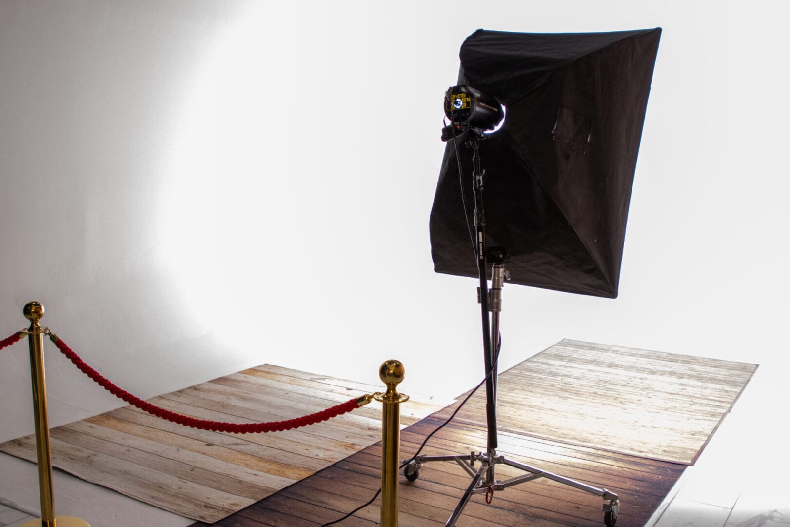 Studio lighting setup with red rope barrier.